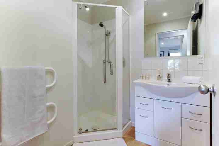 Bathroom in beachfront family home, view of shower and sink