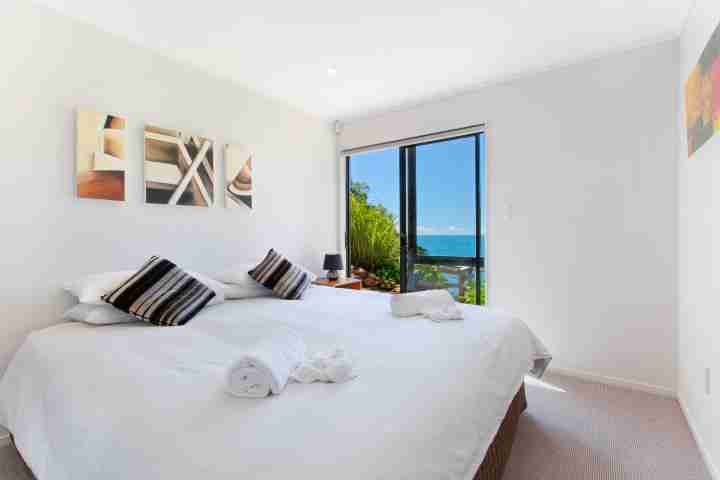 Be my guest in double bedroom with outdoor access at Beachfront Enclosure Bay