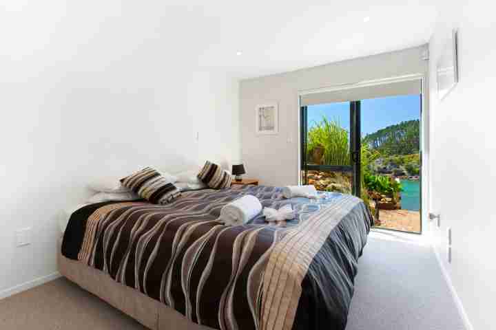 Stay at double bedroom with outdoor access and beach view on Waiheke Island