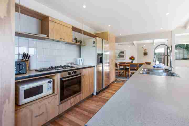 Well-equipped kitchen at family beachfront holiday home for your next Waiheke escape