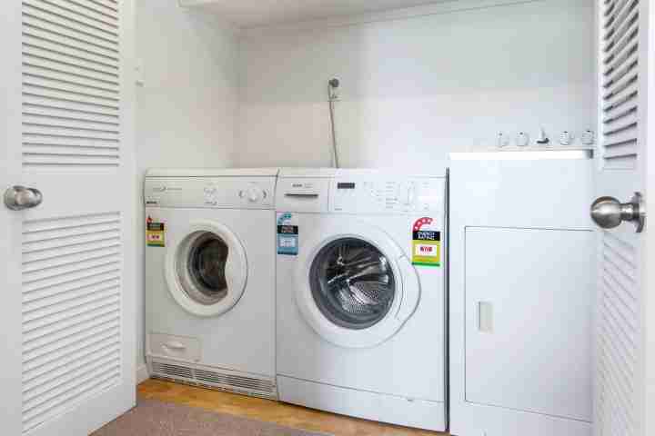 Laundry facilities in well-equipped, beachfront family home
