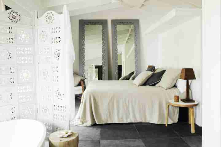 Bedarra Island Cream White Bedroom with Black tiled floor, twin mirrors and wooden lamps