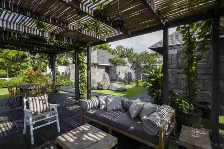 Courtyard and garden area with outdoor dining and traditional Balinese pergola