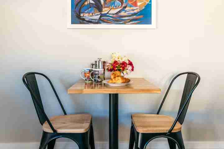 Table and chairs in dining area at Te Whau Apartment