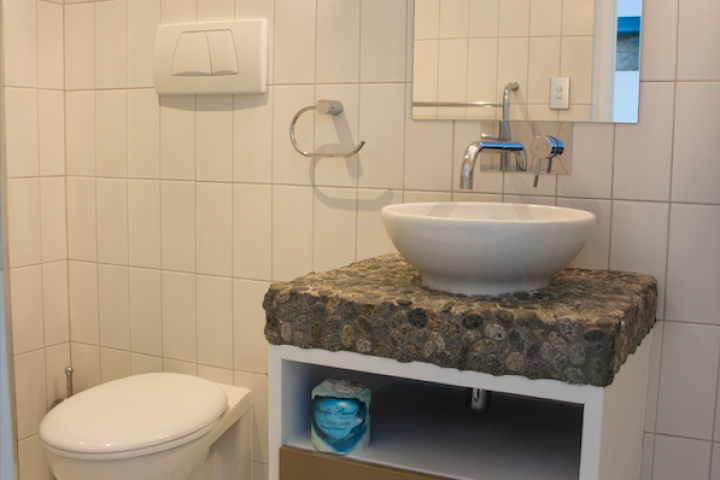 Ensuite bathroom featuring vanity and toilet at Condo on the beach