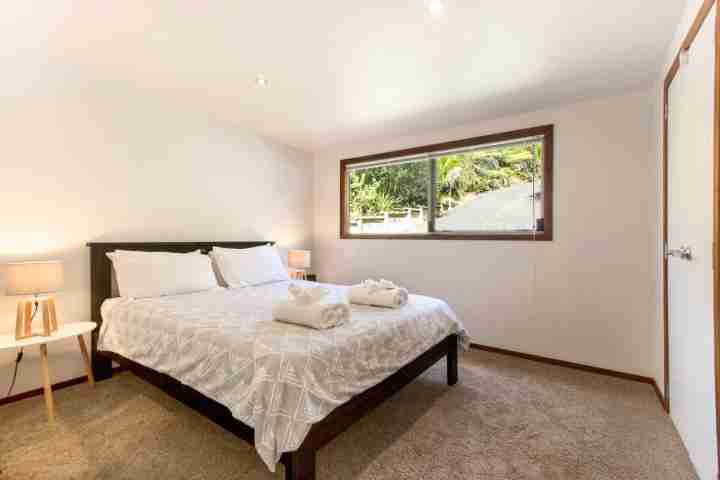 Spacious double bedroom with large wardrobe in Karaka Sanctuart