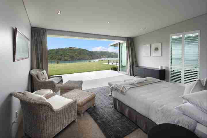 Be my guest in stunning master bedroom with sea view and outdoor flow at Korora estate
