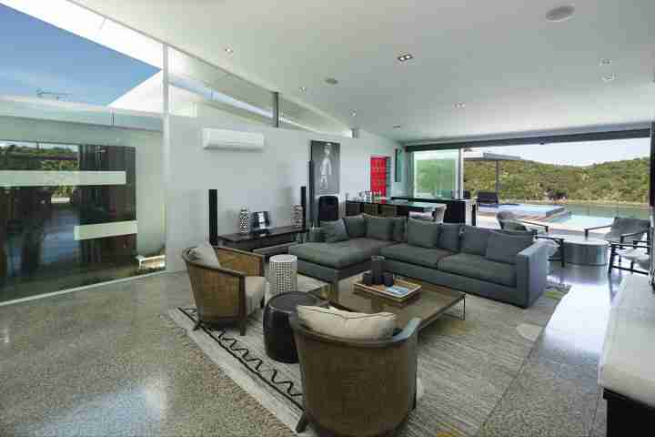 Relax and entertain in Korora Estate Lounge with pool and garden view