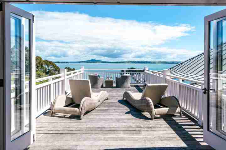 Sunny outdoor deck and loungers on private balcony of luxury Te Rere Estate