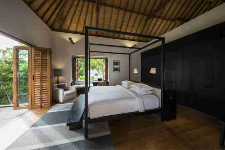 Modern stylish Balinese villa with four poster bed and outdoor deck access