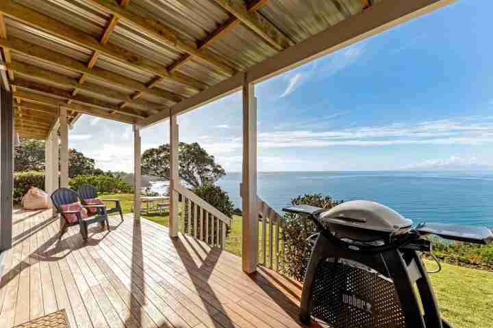 Large sunny deck with outdoor furniture, BBQ and unlimited sea views