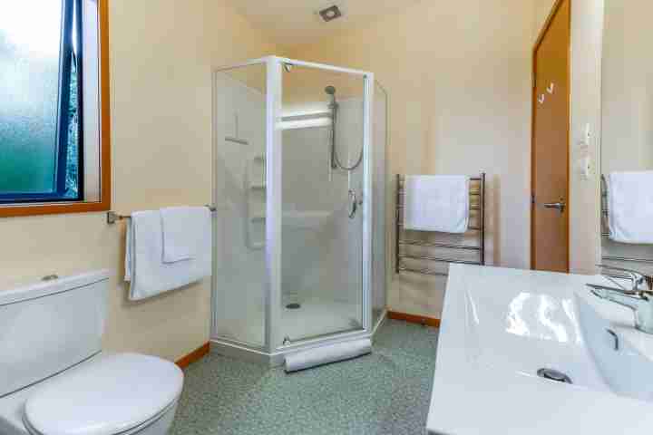 Large bathroom in Waiheke family home with shower, vanity and toilet