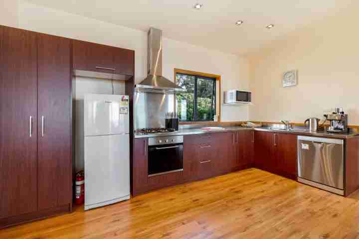 Fully-equipped kitchen with coffee machine in self-catered Waiheke accommodation