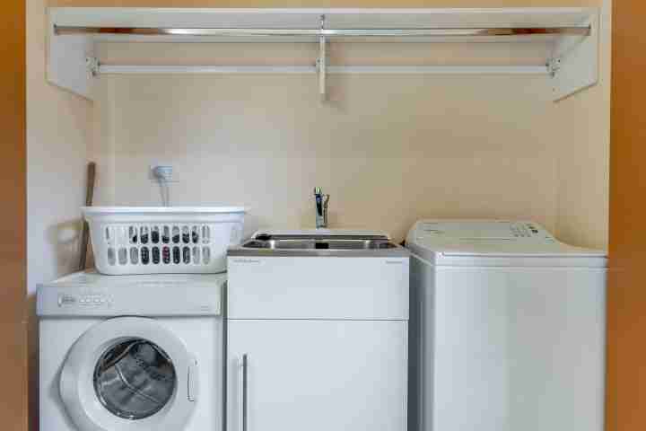 Laundry facilities including washing machine and dryer at Moeraki