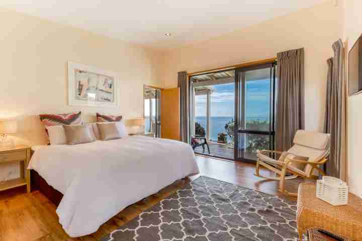 Master bedroom with outdoor access and unlimited sea views