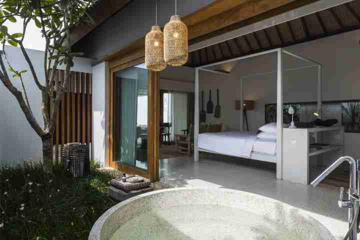 Outdoor stone bathtub with Balinese lights at five star villa