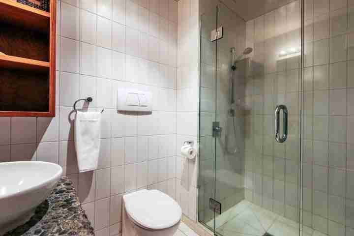 Vanity, toilet and large shower in premium beachfront apartment