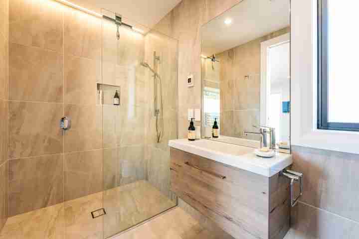Walk in shower and vanity in luxury Te Whau apartment