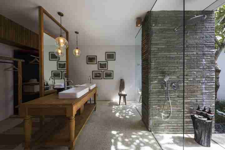 Spacious bathroom with stone shower, large vanity and sensatia botanicals skincare