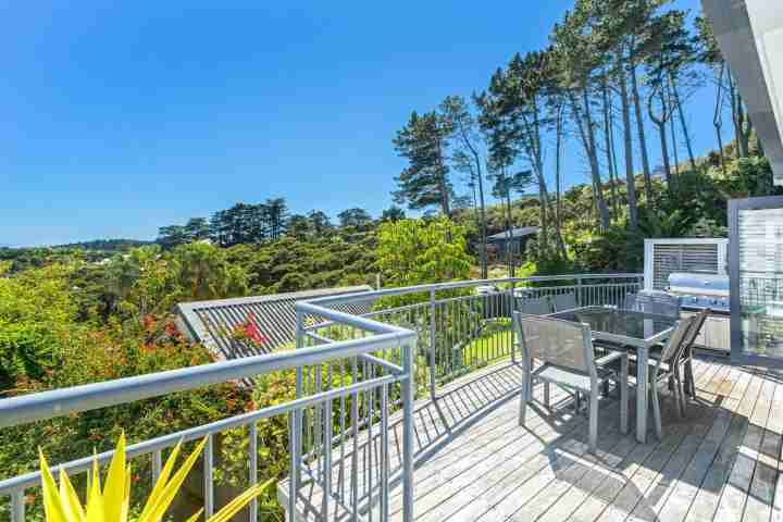 Sunny deck with outdoor dining area, BBQ and sea views