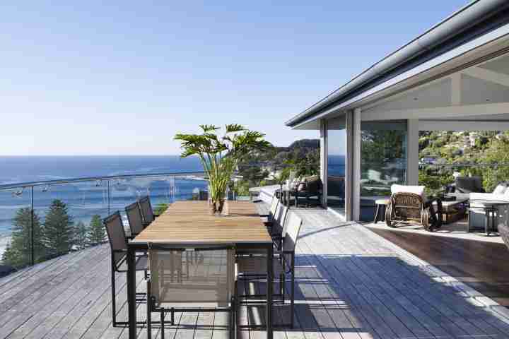 Outdoor dining area with Amaroo Beach view from Whale Beach House in luxury accommodation