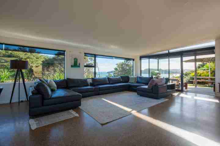 Wharetana Bay Villa Living area with views of the bay