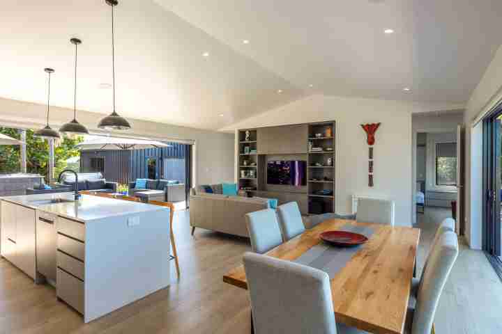 Open plan kitchen and living at Piritahi Beach House by Waiheke Unlimited